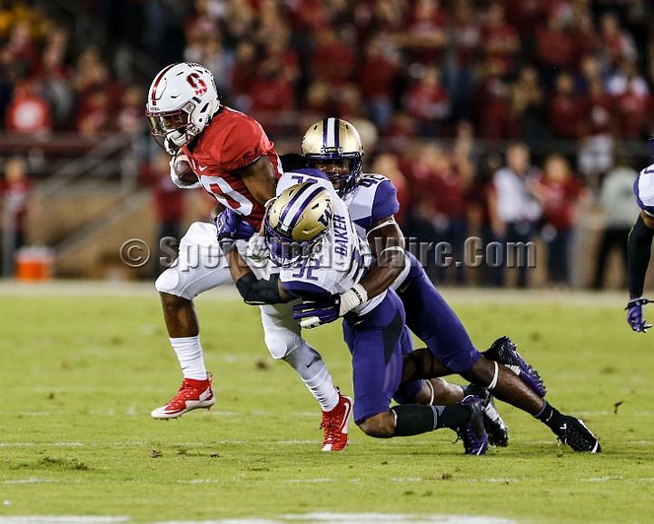 2015StanWash-045.JPG - Oct 24, 2015; Stanford, CA, USA; Stanford Cardinal running back Bryce Love (20) catches a pass for 12 yards and a first down in the first quarter before being tackled by Washington Huskies defensive back Budda Baker (32) and linebacker Cory Littleton (42) at Stanford Stadium. Stanford beat Washington 31-14.